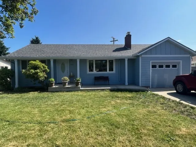 Single-story home with blue-gray board-and-batten siding
