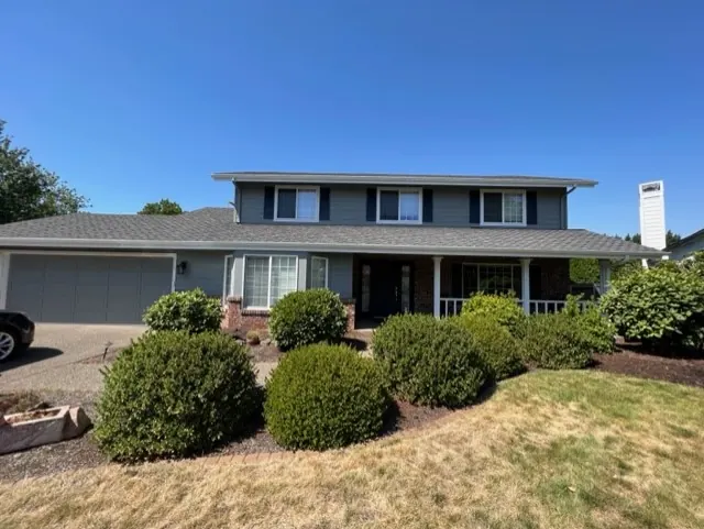 Two-story gray-blue home with a covered front porch