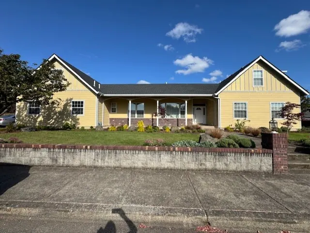 Yellow single-story home with a covered porch and white trim